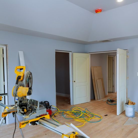 construction-remodeling-home-cutting-wooden-trim-board-with-circular-saw